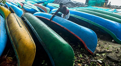 Fishermen place boats away from the shore in view of the rough sea during monsoon season, in Kozhikode, Kerala, Tuesday, May 27, 2025.