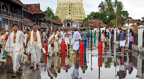 People at the premises of Sree Padmanabhaswamy Temple after rainfall, in Thiruvananthapuram, Friday, May 23, 2025.