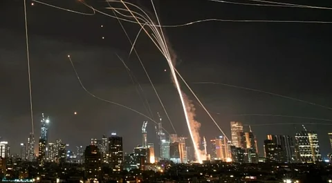 Drones and missiles fly through the night sky over Iran capital as Tehran retaliated to Israel strikes.