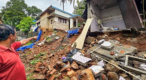 A man shows a portion of a house that collapsed due to heavy rainfall, in Thiruvananthapuram, Saturday, June 14, 2025.