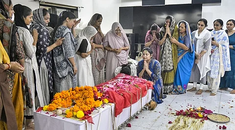 People gather after the mortal remains of First Officer Clive Kunder, co-pilot of the Air India plane that crashed in Ahmedabad last week, were brought to his residence, in Mumbai, Thursday, June 19, 2025.
