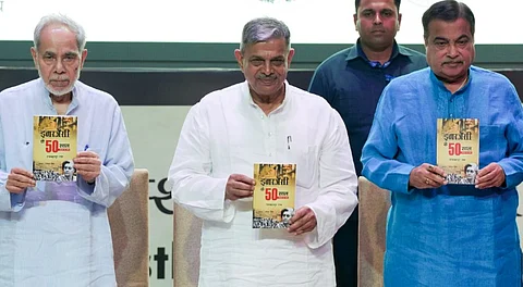 Union Minister of Road Transport and Highways Nitin Gadkari with RSS Sarkaryavah Dattatreya Hosabale and President of the Indira Gandhi National Centre for the Arts (IGNCA) Trust Ram Bahadur Rai releases a book authored by Rai during an event to mark the 50th anniversary of the Emergency imposed in 1975, in New Delhi, Thursday, June 26, 2025.