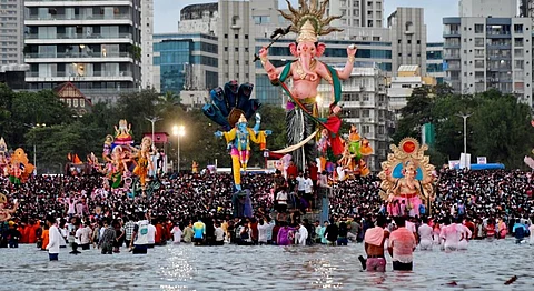 Devotees prepare to immerse idols of Lord Ganesh after the conclusion of Ganesh Chaturthi festival, in Mumbai, Tuesday, Sept. 17, 2024.