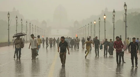 Visitors at the Kartavya Path during rain, in New Delhi, Sunday, June 29, 2025.