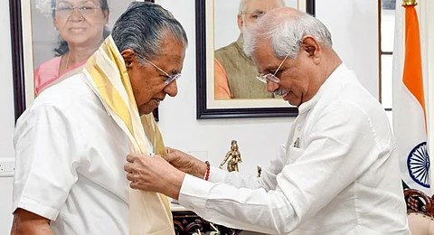 Kerala Governor Rajendra Arlekar greets Chief Minister Pinarayi Vijayan during the latter's visit to the Raj Bhavan, in Thiruvananthapuram, Sunday, July 20, 2025.
