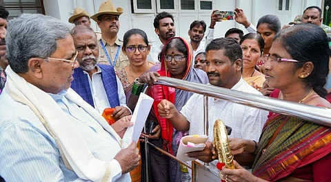 Karnataka Chief Minister Siddaramaiah interacts with people as he listens to their grievances.
