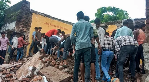 Locals during the rescue work after a government school building collapsed, in Jhalawar district, Rajasthan, Friday, July 25, 2025.