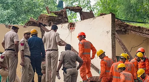Police and rescue team inspect the collapsed portion of Humayun's Tomb.