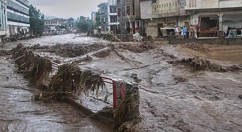 Local residents look at flash flooding due to heavy rains in a neighborhood of Mingora, the main town of Swat Valley, northwestern Pakistan.