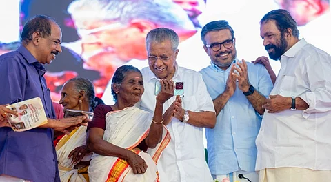 Kerala Chief Minister Pinarayi Vijayan interacts with 76-year old Sarada Kani and 75-year old Vishalakshi, both of whom underwent training as part of the 'Digi Kerala project', during an event where the state was declared as the first fully digitally literate State in India, in Thiruvananthapuram, Thursday, Aug. 21, 2025.