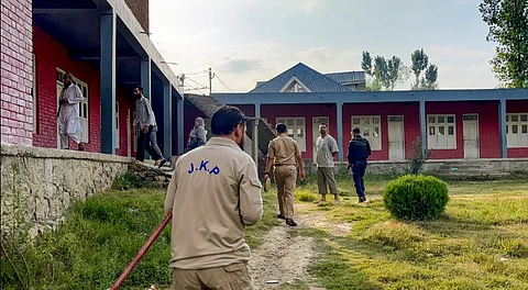 Jammu and Kashmir police officials at a school at Wanabal Rawalpora, in Srinagar, Saturday, Aug. 23, 2025.