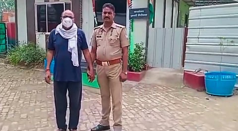 Police personnel with father-in-law of Nikki, the 26-year-old woman who was allegedly set ablaze for dowry, after his arrest, in Greater Noida, Monday, Aug. 25, 2025.