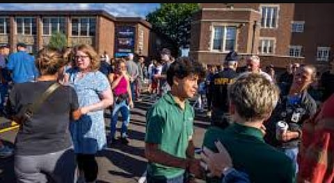 Students and parents await news during a mass shooting at the Annunciation Catholic School in Minneapolis on Wednesday, Aug. 27, 2025.