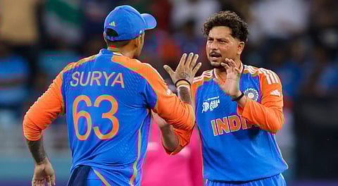 In this image released on Sept. 10, 2025, India's Kuldeep Yadav celebrates with captain Suryakumar Yadav after taking the wicket of UAE's Rahul Chopra during the Asia Cup 2025 match between India and UAE, in Dubai.