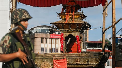 Nepalese soldier stands guard near the chariot of Kumari during the last day of the week-long Indra Jatra festival celebrations at the UNESCO World Heritage Site Basantapur Durbar Square, amidst the curfew imposed following anti-government protests, in Kathmandu, Nepal, Thursday, Sept. 11, 2025.