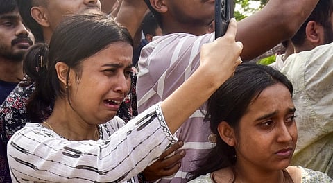 People mourn as the mortal remains of singer Zubeen Garg being taken to his residence from the Guwahati airport, Sunday, Sept. 21, 2025.