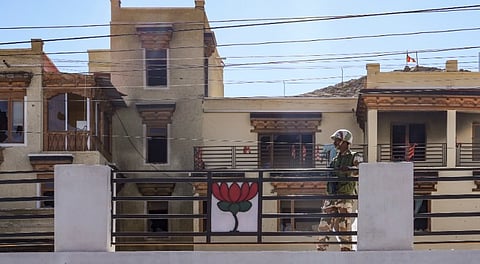 Security personnel stand guard at the ransacked BJP office in Leh, Ladakh, Thursday, Sept. 25, 2025.