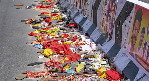 Footwear and other belongings of people lie on a road in the aftermath of stampede during a rally of actor and Tamilaga Vetri Kazhagam (TVK) chief Vijay, in Karur district, Tamil Nadu, Monday, Sept. 29, 2025.