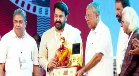 Mohanlal receives momento from Kerala CM Pinarayi Vijayan.