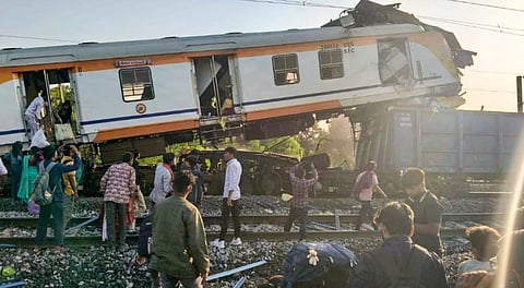People gather after a passenger train collided with a goods train near Bilaspur railway station, Chhattisgarh, Tuesday, Nov. 4, 2025.