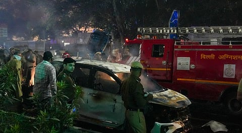 Police personnel at the spot after a blast occurred in a parked car near Red Fort, leaving multiple vehicles in flames, in New Delhi, Monday, Nov. 10, 2025.