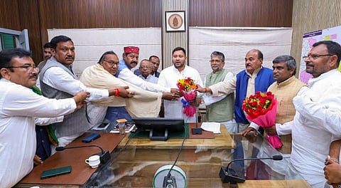Newly elected RJD MLAs and others greet party leader Tejashwi Yadav after he was elected as the legislature party leader during a meeting, in Patna, Monday, Nov. 17, 2025.