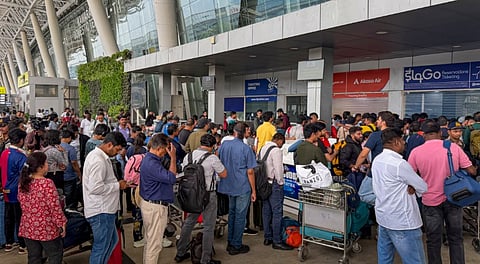Passengers wait in queues to enquire about flight status at Chennai Airport amid IndiGo flight disruptions, Friday, Dec. 5, 2025.