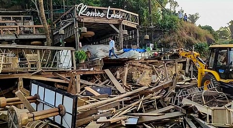 An excavator demolishes wooden structures at Romeo Lane on Anjuna beach after a fire at the adjacent Birch by Romeo Lane nightclub killed 25 people, as the state administration begins pulling down the tourism property, in Goa, Tuesday, Dec. 9, 2025.