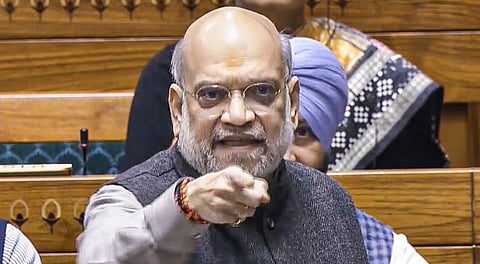 Union Home Minister Amit Shah speaks in the Lok Sabha during the Winter session of Parliament, in New Delhi, Wednesday, Dec. 10, 2025.