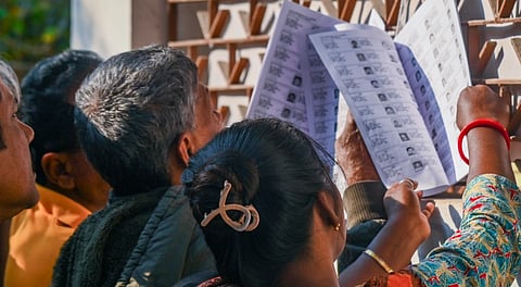Voters check their names in West Bengal's draft electoral rolls following the Special Intensive Revision (SIR), in Balurghat, Dakshin Dinajpur, Tuesday, Dec. 16, 2025.
