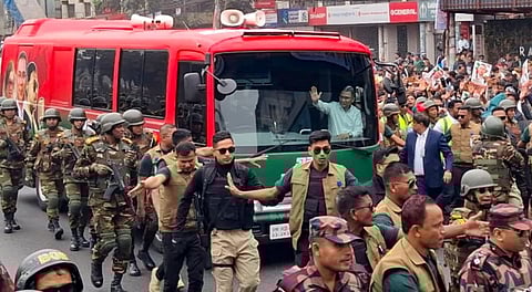 Bangladesh Nationalist Party (BNP) Acting Chairman Tarique Rahman waves to supporters as he is escorted by security personnel upon his return after over 17 years in self-exile, in Dhaka, Bangladesh, Thursday, Dec. 25, 2025.