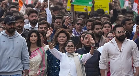 West Bengal Chief Minister and Trinamool Congress (TMC) chief Mamata Banerjee leads a protest march accompanied by party leaders including Dev and June Maliah and others against the Enforcement Directorate's searches linked to political consultancy firm I-PAC, in Kolkata, Friday, Jan. 9, 2026.