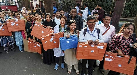 Polling officials with EVMs and other election material before leaving for their respective polling booths ahead of Navi Mumbai Municipal Corporation election, in Navi Mumbai, Wednesday, Jan. 14, 2026.
