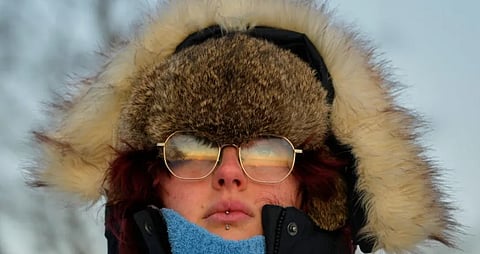Emma Nadeau, of North Yarmouth, Maine, is bundled against the cold as she watches the sunrise on a 1-degree F. morning, Saturday, Jan. 24, 2026, in Portland, Maine.