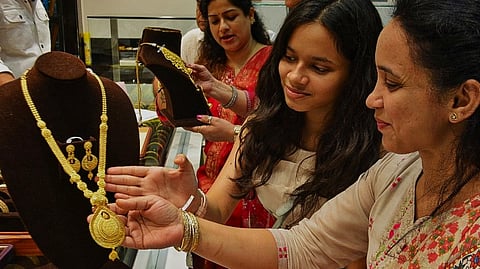 Women purchase jewellery at a showroom on the occasion of 'Dhanteras', in Thane, Maharashtra, Saturday, Oct. 18, 2025.