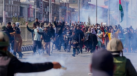 People from the Muslim community raise slogans amid tear smoke fired by police at a protest over the killing of Iran's Supreme Leader Ayatollah Ali Khamenei in joint air strikes by the US and Israel, after authorities imposed severe restrictions on the movement of people in parts of Kashmir, Srinagar, Monday, March 2, 2026.