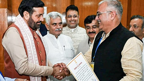 In this image posted on March 17, 2026, Haryana Chief Minister Nayab Singh Saini, left, exchanges a handshake with Sanjay Bhatia, who was elected as a Rajya Sabha MP from Haryana.