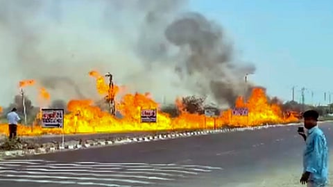 Flames and thick smoke rise from the roadside after a diesel-filled tanker overturned on NH-68, in Jalore district, Rajasthan, Wednesday, March 18, 2026.