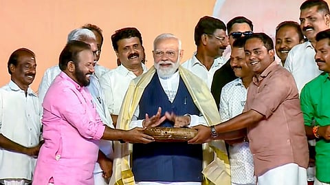 Prime Minister Narendra Modi, centre, being felicitated during a public meeting ahead of the Kerala Assembly elections, in Thiruvalla, Kerala.