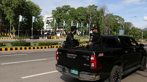 Pakistani security officials drive through the Red Zone where most of the diplomatic missions and government offices are located, as security is intensified ahead of the visit of United States and Iranian delegations in Islamabad.