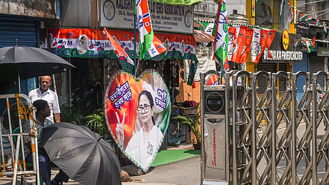 TMC flags and posters featuring Mamata Banerjee line a street leading to her residence on the day of Assembly election results, in Kolkata, Monday, May 4, 2026.