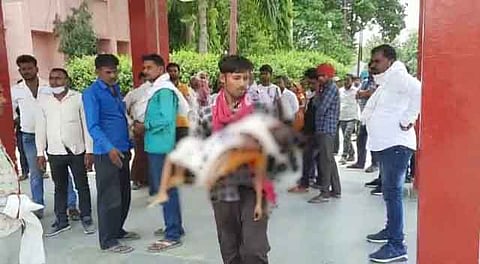 गोद में बेटे का शव लिए दौड़ता हुआ पिता