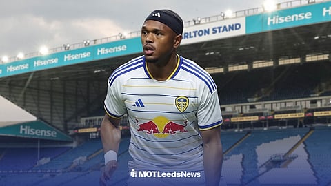 Lois Openda playing in a Leeds United kit in front of Elland Road.