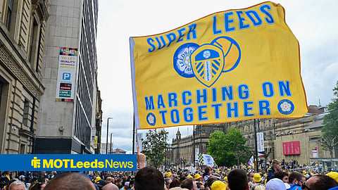 Leeds United fans gather in street with Marching on Together flag
