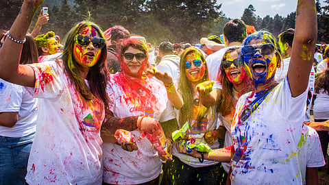 Colorful fun! Smiles and laughter are shared among participants as they revel in the joy of Holi, a vibrant Hindu festival celebrated by Mexico's Indian Association at La Marquesa National Park.