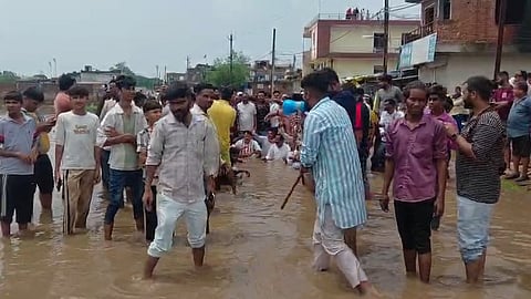 Congress MLA Sahab Singh Gujjar sits in Water