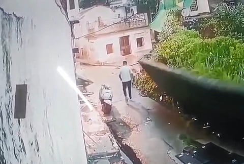A Youth Narrowly Escapes as a Dilapidated Wall Collapses