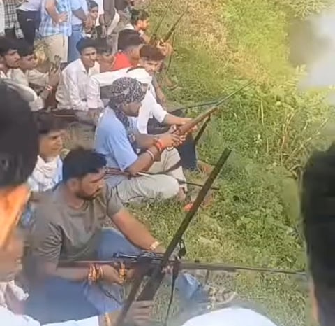 Gunmen Aim at a Clay Pot During a Bhujariya Festival