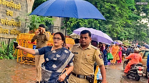 Cop Holding Umbrella For Nashik MLA Devyani Pharande
