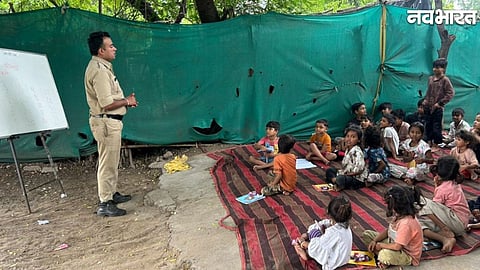 Home Guard jawan Sanjay Savare teaching children under a tree.